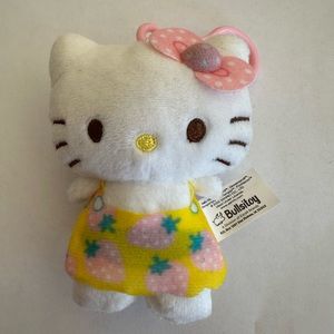 Hello Kitty plush dangler with yellow strawberry skirt and pink clip
